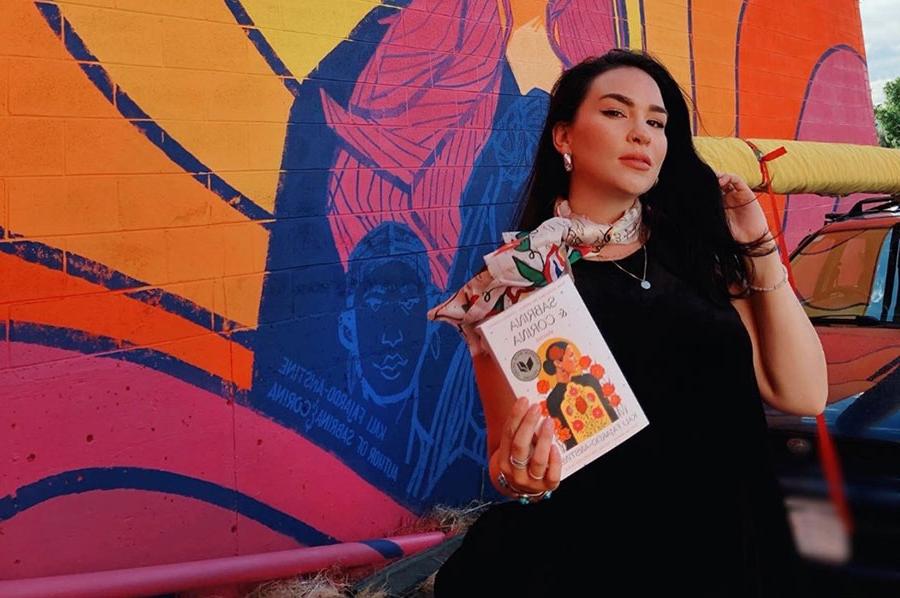 Kali-Fajardo-Anstine stands next to a mural created by Kaitlin Orin and Adam Raiola, at Nopalito's in Boulder Colorado.